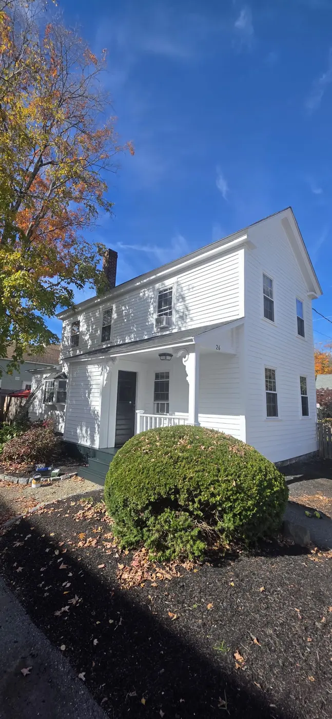 White colonial home after a full exterior repaint