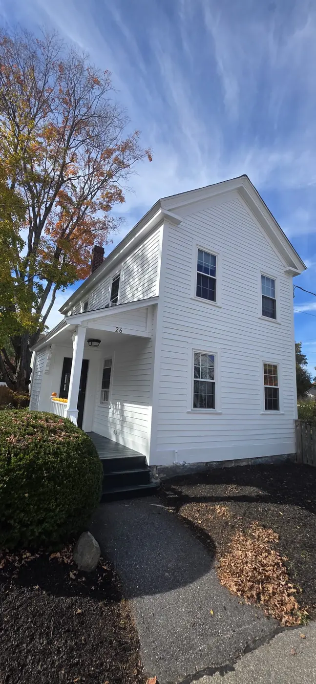 White colonial home after a full exterior repaint by Family Art Painting