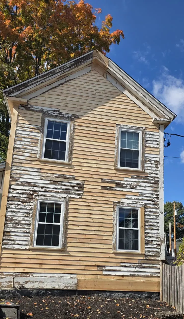 Before: peeling paint across the gable end